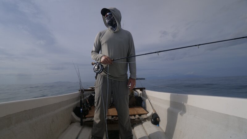 Brian Jill stands at the ready with his fishing pole on a boat in Papua New Guinea. – Bild: Discovery Communications, LLC
