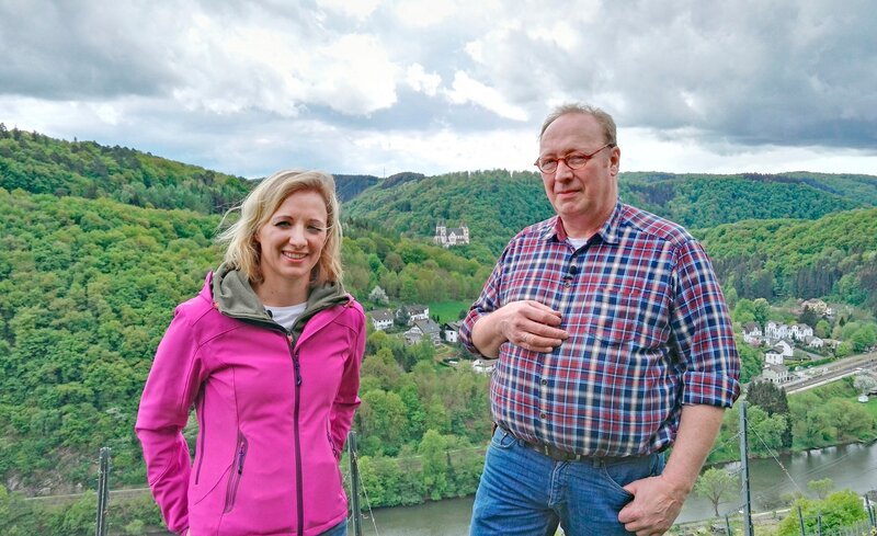 Anna Lena mit Uwe Haxel, einem der fünf Winzer an der Lahn, vor schöner Kulisse mit Kloster Arnstein. – Bild: SWR/​Daniel Borger