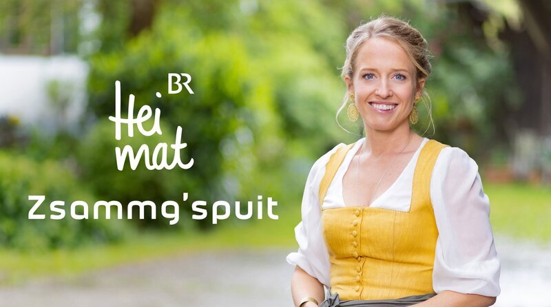 Key Visual/​Cover Sendereihenbild mit Typo zu „BR Heimat – Zsammg’spuit“. Susanne Wiesner (im Bild) erkundet ausgewählte Regionen in Bayern und dem angrenzenden Alpenraum. Sie trifft auf heimische Volksmusikanten und erkundet Geschichte, Brauchtum und Handwerkskunst der jeweiligen Gegend. – Bild: BR/​Markus Konvalin/​Montage: BR