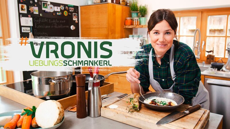 Key Visual Sendereihenbild mit Typo zu „Vronis Lieblingsschmankerl“. Vroni (Veronika Lutz) beugt sich über dem Küchentresen. – Bild: HR/​BR/​Gebrüder Ungehobelt Mediamanufaktur/​Sebastian Fery/​Montage: BR