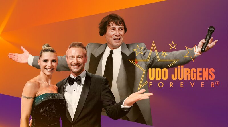 „Udo Jürgens Forever“. Namhafte Stars der Musikszene erweisen der Sänger-Legende mit ihren Auftritten die Ehre; Moderatorenduo Michelle Hunziker und Sasha mit Udo Jürgens im Hintergrund. – Bild: BR/​UJM/​Kevsan Gündüz/​Montage: BR