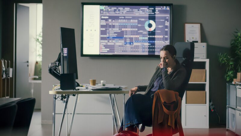 Giselle Moser (Gina Henkel) ist schockiert über den Tod ihres Geschäftspartners und trauert alleine im Büro. – Bild: Christian Diaz /​ ZDF