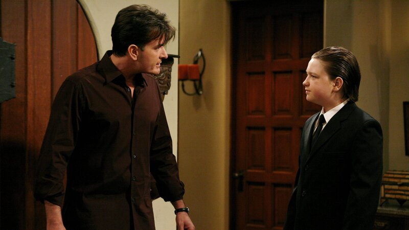 Jake (Angus T. Jones, r.) hat sich in Milly, die Tochter von Jess verliebt und bittet Charlie (Charlie Sheen, l.), ein gemeinsames Essen zu arrangieren. – Bild: HBO