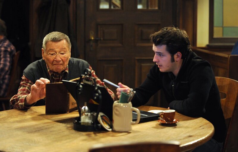 Alois und Flori können die Sütterlinschrift nicht entziffern. Von links: Alois Preissinger (Erich Hallhuber) und Florian Brunner (Tommy Schwimmer). – Bild: BR/​Marco Orlando Pichler