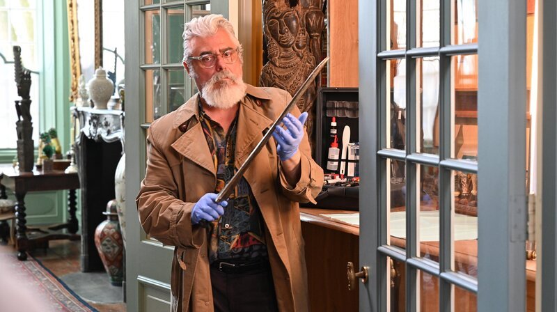 Eine besondere Waffe: Pathologe Hendrik Davie (Darrell D’Silva) schaut sich das Schwert genauer an. – Bild: ARD Degeto/​Company Pictures, NL Films/​All3Media International