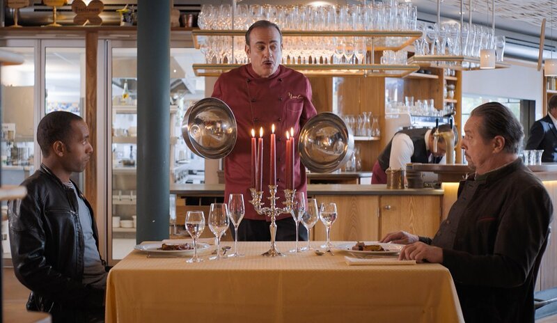 Beissl (Andreas Giebel, M.) und Jerry (Peter Marton, l.) werden im Restaurant Nouvelle Cuisine von Michelle Perrin persönlich bedient. – Bild: ARD/​Lucky Bird Pictures/​Andras Steffan