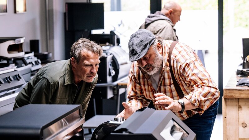 Kommissar Matti Wagner (Pierre Besson, l.) begeistert sich in seiner Freizeit für Grills und lässt sich im Grillfachmarkt von Stefan Ständler (Waldemar Kobus, r.) beraten. Kurze Zeit später gerät der Geschäftsführer unter Mordverdacht. (Komparse im Bild) – Bild: ZDF und Martin Rottenkolber