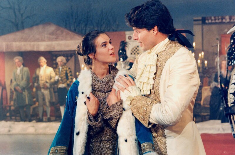 MDR FERNSEHEN ZUM 60. GEBURTSTAG VON KATARINA WITT: DIE EISPRINZESSIN, am Donnerstag (04.12.25) um 23:10 Uhr. Bei einem Fest auf dem zugefrorenen See vor dem königlichen Schloss macht sich der Prinz auf, seine zukünftige Braut zu finden. Auch Ella ist unter den Gästen. Seit dem Verlust ihrer Mutter lebt sie im Hause des Grafen, wo sie den Launen seiner Töchter ausgesetzt ist. Als der Blick des Prinzen auf Ella fällt, ist es um ihn geschehen. Katarina Witt als Ella und Christopher Barker als Prinz – Bild: MDR MDR FERNSEHEN ZUM 60. GEBURTSTAG VON KATARINA WITT: DIE EISPRINZESSIN, am Donnerstag (04.12.25) um 23:10 Uhr. Bei einem Fest auf dem zugefrorenen See vor dem königlichen Schloss macht sich der Prinz auf, seine zukünftige Braut zu finden. Auch Ella ist unter den Gästen. Seit dem Verlust ihrer Mutter lebt sie im Hause des Grafen, wo sie den Launen seiner Töchter ausgesetzt ist. Als der Blick des Prinzen auf Ella fällt, ist es um ihn geschehen. Katarina Witt als Ella und Christopher Barker als Prinz – Bild: MDR