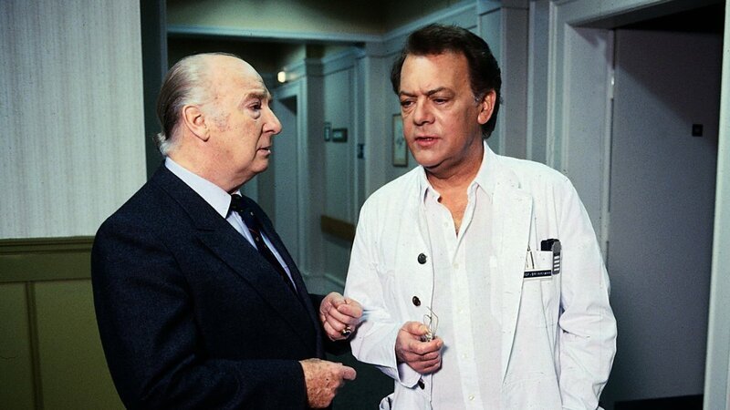 Schon wieder hat Verwaltungsdirektor Mühlmann (Alf Marholm, l.) Kummer, weil Professor Brinkmann (Klausjürgen Wussow, r.) einen von einer einflussreichen Persönlichkeit empfohlenen Arzt für die Klinik ablehnt. – Bild: Thomas Waldhelm