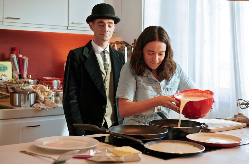 Mia (Hope Lloyd) und Pan Tau (Matt Edwards) machen Pfannkuchen. – Bild: ARD/​Caligari/​Film2020