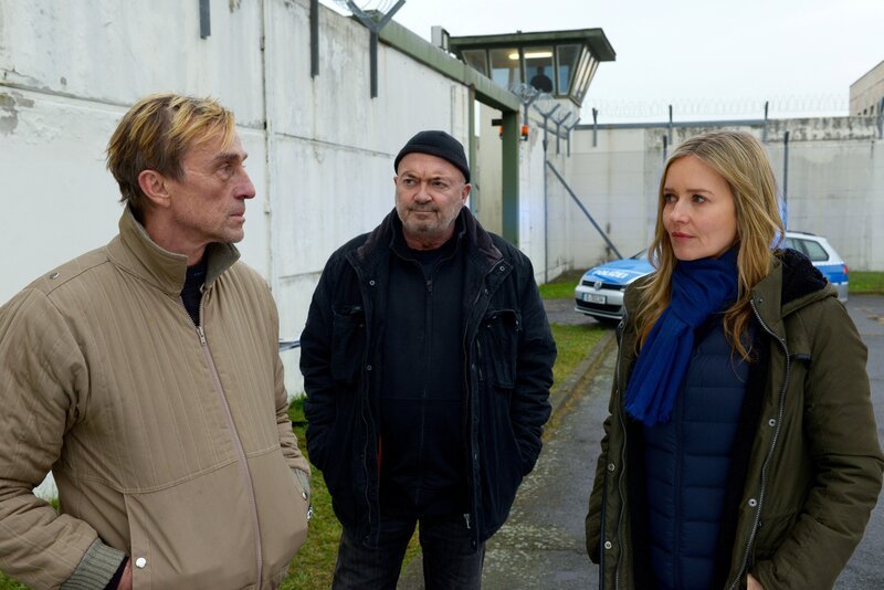 Am Tag seiner Haftentlassung entkommt Peter Kniesbeck (André M. Hennicke, l.) nur knapp einem Anschlag. Otto Garber (Florian Martens, M.) und Linett Wachow (Stefanie Stappenbeck, r.) wollen von ihm wissen, wer dahinterstecken könnte. – Bild: Katrin Knoke /​ ZDF Enterprises GmbH /​ Die Verwendung ist nur bei redaktioneller Berichterstattung im Rahmen einer Programmankündigung ab 2 Monate vor der ersten Auss /​ © ZDF/​Katrin Knoke