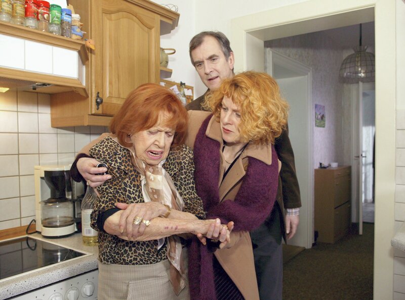 MDR Fernsehen IN ALLER FREUNDSCHAFT FOLGE 225, „Vergesslichkeiten“, am Samstag um 15:10 Uhr. Maria Herrmann hat versehentlich einen Topf mit Fritieröl umgeworfen und sich dabei schwere Verbrennungen zugezogen. Ihr Sohn Bernd und seine Frau Krista beruhigen die verletzte Maria. Maria Herrmann (Brigitte Mira), Krista Herrmann (Joanne Gläsel) und Bernd Herrmann (Peter Prager). – Bild: MDR/​Krajewski