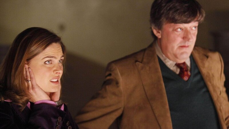 Brennan (Emily Deschanel) und Dr. Wyatt (Stephen Fry) versuchen ein Opfer aus der Heavy Metal-Szene zu identifizieren. – Bild: TVNOW /​ FOX