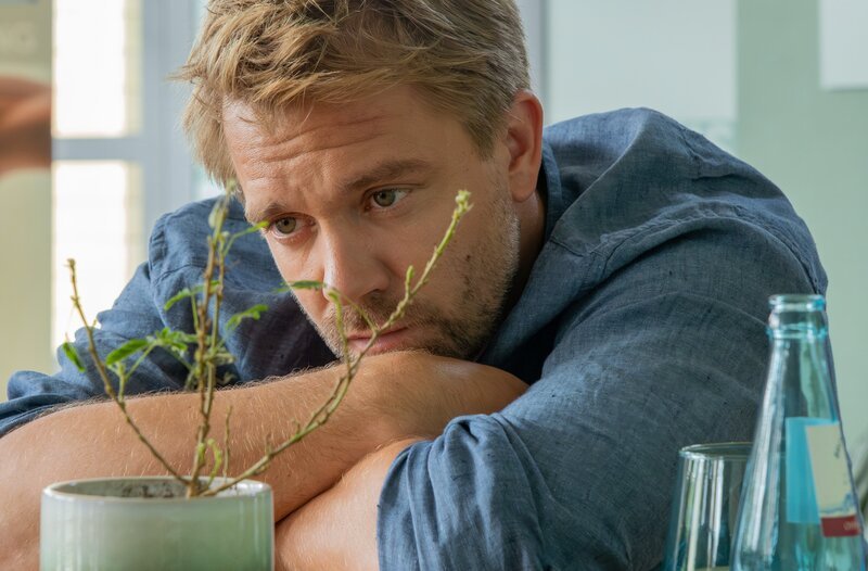 Dr. Lilly Phan hat ihre Verlobung mit Björn Lodinson (David Korbmann) aufgelöst. Doch im Gegensatz zu Lilly scheint Björn Geduld regelrecht erfunden zu haben. So sitzt er wieder im Foyer der Sachsenklinik, wartet auf Lilly und gibt ihr alle Zeit der Welt, ihre Entscheidung zu festigen oder zu ändern. – Bild: MDR/​Saxonia Media/​Sebastian Kiss