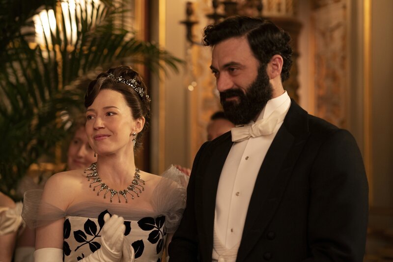 l-r: Bertha Russell (Carrie Coon), George Russell (Morgan Spector) – Bild: Warner /​ Die Verwendung ist nur bei redaktioneller Berichterstattung im Rahmen einer Programmankündigung ab 2 Monate vor der ersten Auss /​ © 2021 Home Box Office, Inc. All rights reserved. HBO® and all related programs are the property  …