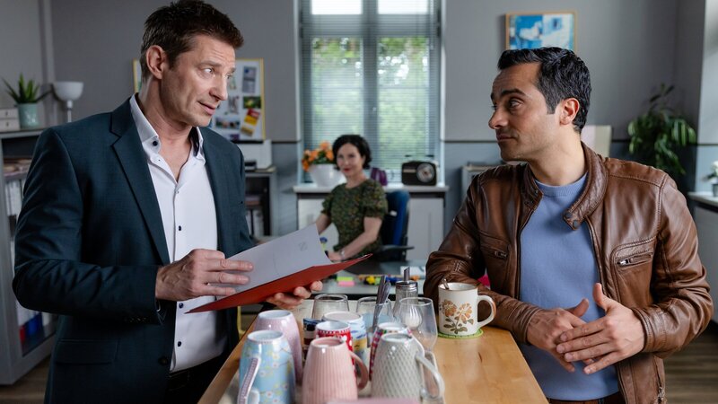 Wird die Akte, die Frau Stockl (Marisa Burger, M.) für die Kommissare Hansen (Igor Jefti?, l.) und Kaya (Baran Hêvî, r.) zusammengestellt hat, die Ermittlungen voranbringen? – Bild: ZDF und Markus Sapper