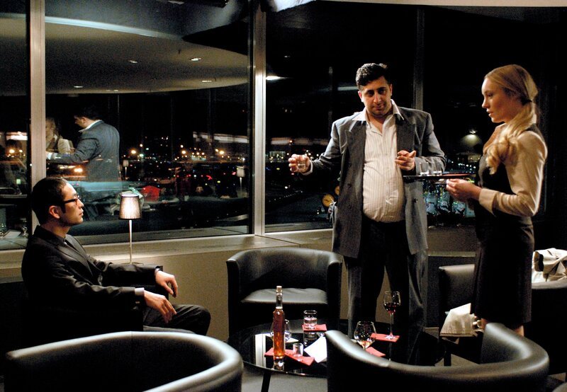 ARD/​HR TATORT, Der tote Chinese, Kriminalfilm, Deutschland, Tony Wang (Chike Chan, links) trifft sich mit dem Geschäftsmann Shavkat Nazarov (Kida Khodr Ramadan) im Flughafenrestaurant. Rechts: Airport-Kellnerin Sylvia (Katharina Heyer). – Bild: ARD Degeto/​HR/​Bettina Müller