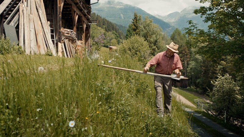 Bergbauer und Künstler Heinrich Untergantschnig beim Sensen vor seinem Hof, Grafenberg, Mölltal, Kärnten – Bild: Red Bull Media House/​ServusTV