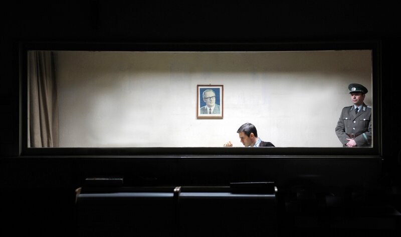 Robert Schnyder (Steffen Groth, l.) wird wegen Beihilfe zur Republikflucht in einer Baracke am Grenzübergang festgehalten. – Bild: rbb/​Julia Terjung