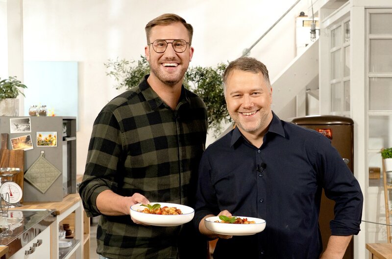 Zu Gast: Anton Schmaus (re.), ein Ur-Bayer, der für moderne, weltoffene Küche mit bayerischen Wurzeln steht. Er kocht Pasta mit Sucuk. Der Karlsruher Spitzenkoch Sören Anders bekocht ihn traditionell – mit Zwiebelrostbraten. Dazu gibt es leckere, knusprige Bratkartoffeln. Als gemeinsames Rezept aus den Resten kreieren beide Köche eine „schwedische Kartoffelpfanne“. – Bild: SWR/​2 Bild GmbH