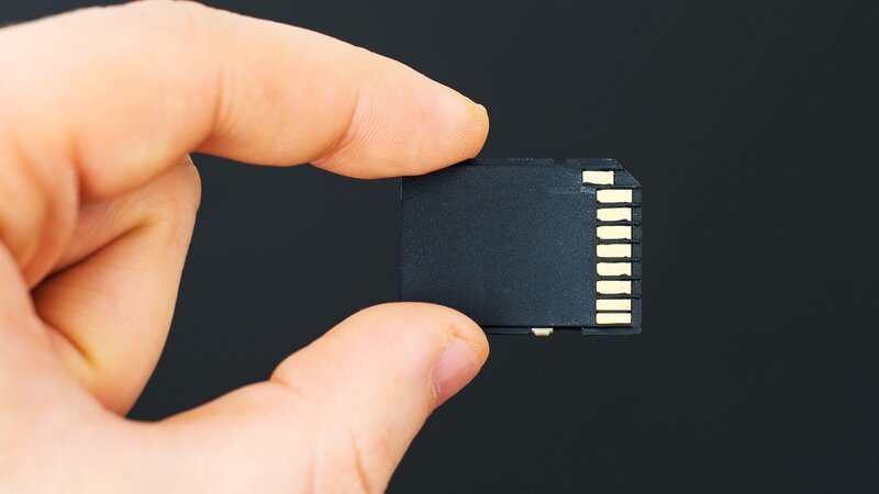 Male hand holding SD card on black background. – Bild: DmitriMaruta /​ Getty Images/​iStockphoto /​ ThinkstockPhotos-469625910 /​ DMITRI MARUTA
