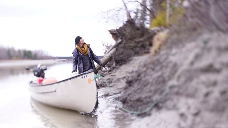 Jennifer standing in boat along riverbank. – Bild: Discovery Communications, LLC
