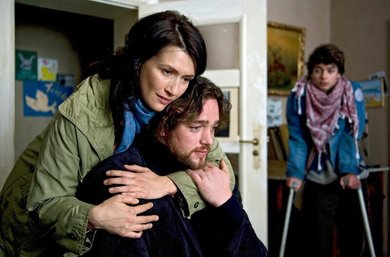 Nicole (Claudia Mehnert, l.) und ihr Sohn Thomas (Max Hegewald, r.) sind überglücklich, Robert (Ronald Zehrfeld, M.) wieder zu Hause zu haben, der von der Haft sichtlich gezeichnet ist. – Bild: ZDF/​ARD/​Julia Terjung