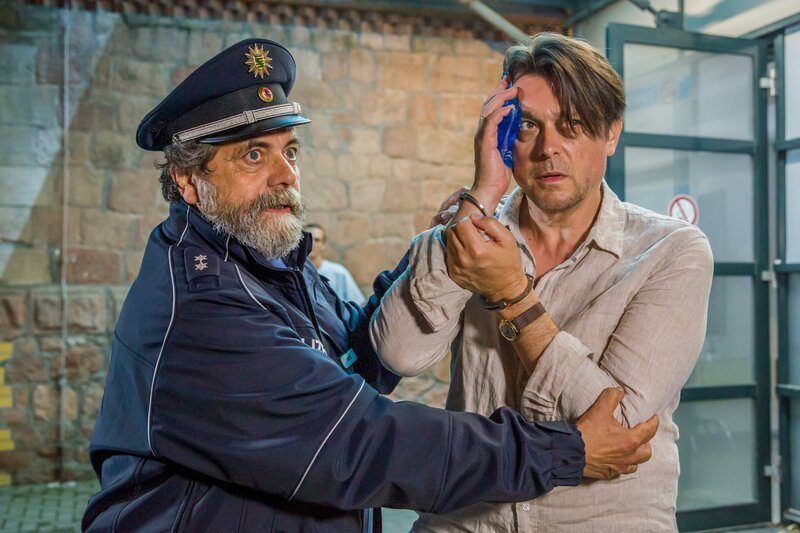 Philipp verletzt sich beim Versuch die kleine Isalie zurückzuholen und wird von Katrins Polizisten nach Hause gebracht. (v.li.): Polizeibeamter (Matthias Brenner), Philipp Esch (Hary Prinz). – Bild: ORF/​MDR/​Ariane Krampe-Filmproduktion/​Steffen Junghans