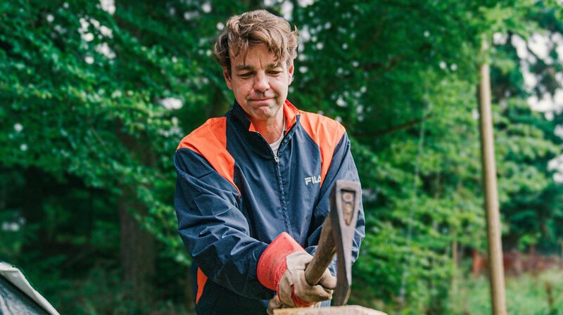 Bernd beim Holzhacken eines umgestürzten Baumes. – Bild: rbb/​ITV