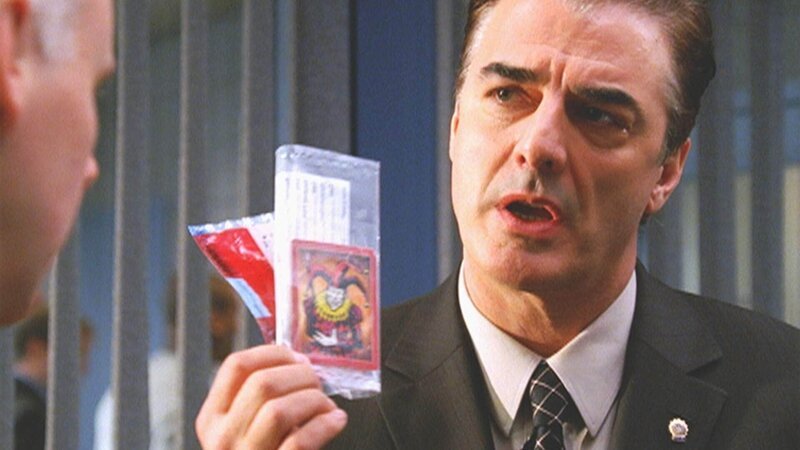 Detective Logan (Chris Noth) geht der Herkunft einer Spielkarte nach, die auf der Leiche eines erschossenen Schülers gefunden wurde. – Bild: RTL