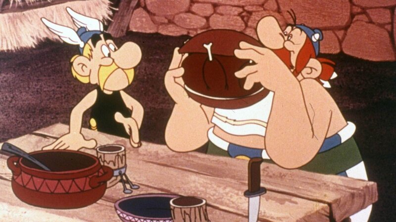 Asterix (li.) und Obelix (re.) schmeckt das Essen bei den Ägyptern hervorragend. – Bild: SUPER RTL