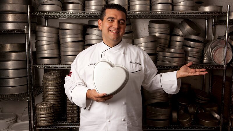 Buddy Valastro posing in front of cake pans. – Bild: Discovery Communications