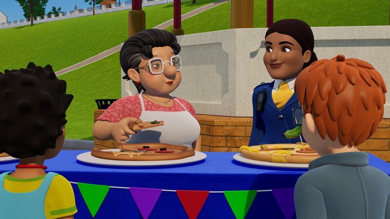 Jurorin Bella probiert die Pizzas, die die Back-Teams kreiert haben. – Bild: KiKA/​Prism Art & Design Limited