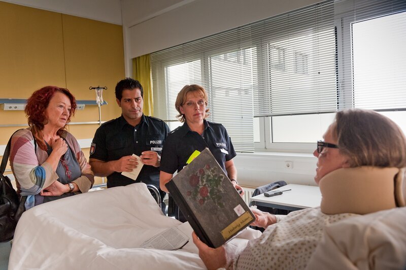 Selbst im Krankenbett dirigiert Theaterregisseur Harting (Hannes Hellmann, r.) alles und jeden. Doch während die Souffleuse Maus (Barbara Focke, l.) dies wortlos mit sich machen lässt, sagen Claudia (Janette Rauch, 2.v.r.) und Tarik (Serhat Cokgezen, 2.v.l.) ihm gehörig die Meinung. – Bild: Boris Laewen /​ ZDF