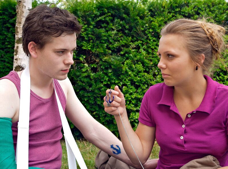 Nina Meinhardt (Leonie Fromme) bemerkt an Tims Wehners (Florian Bartholomäi) Arm eine Tätowierung, die fast genauso aussieht, wie das Amulett ihres Großvaters. Für Nina kann das kein Zufall sein. Sie sieht es als Zeichen und hängt sich an Tim. – Bild: MDR/​Krajewsky