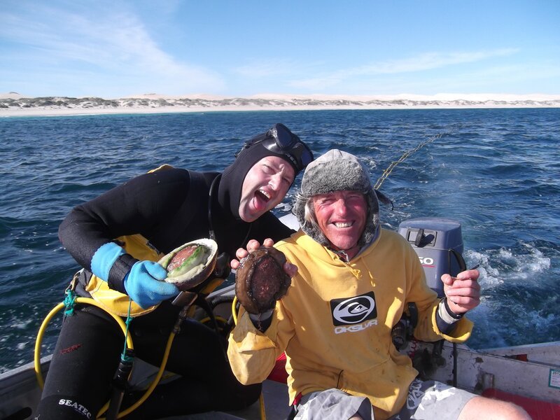 Abalone Sheller Tony Custance and Abalone Diver Jay Haagmans on boat holding up fresh caught abalone. – Bild: Discovery Communications