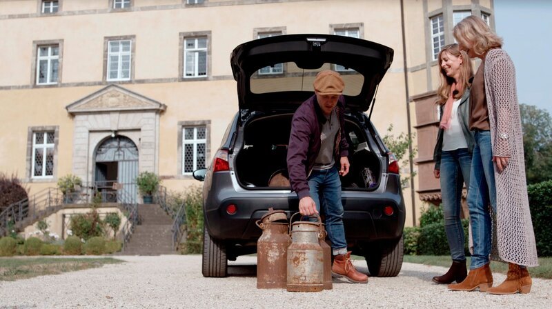 Oli P. begrüßt Elfi Falkenstein und ihre beste Freundin Jutta Schmidt, die einen alten Ofen und ein paar zerbeulte Milchkannen mitgebracht haben. – Bild: WDR/​Encanto Film- und Fernsehproduktions GmbH