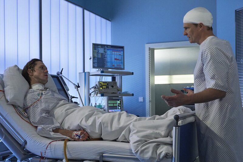 Als Ralf Noack (Timo Jacobs, li.) erwacht, steht Jan Fischer (Thorsten Nindel, re.) an seinem Bett. Jan ist froh, dass es seinem Freund und Kollegen wieder besser geht. Ralf jedoch ahnt, warum Jan wirklich da ist. Er will wissen, ob Ralf sich an den Überfall erinnern kann. – Bild: MDR/​MDR/​Saxonia/​Wernicke