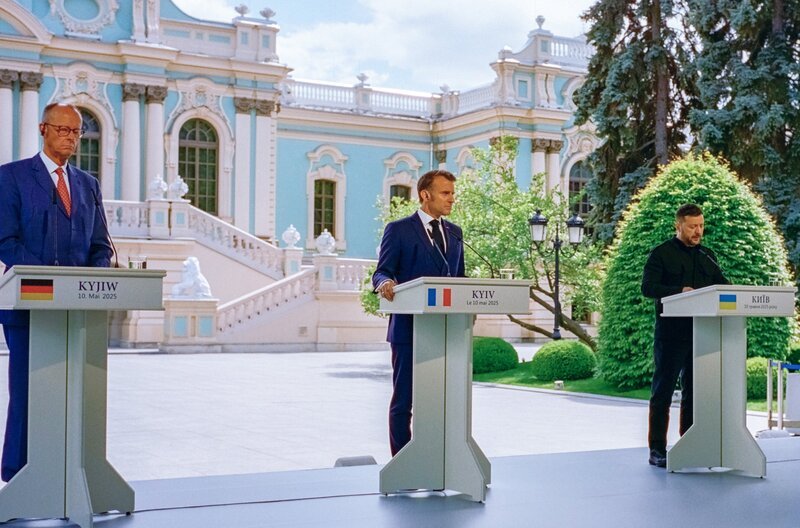 Zusammenstehen – Friedrich Merz (li.) und Emmanuel Macron (Mi.) erheben gemeinsam ihre Stimme gegen den Aufstieg des Imperialismus, ob an der Seite des ukrainischen Präsidenten Wolodymyr Selenskyj (re.) oder Grönlands. – Bild: Victor Peressetchensky