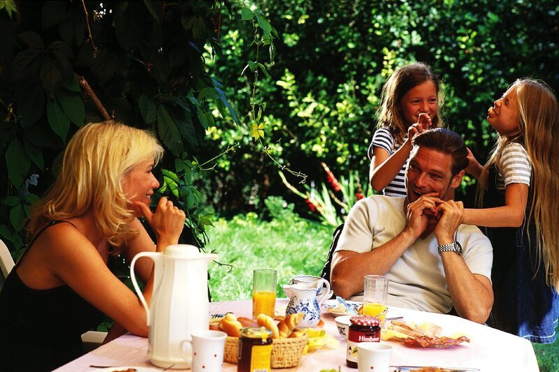 Hier scheint die Welt fast in Ordnung: Thomas (Manfred Stücklschwaiger) frühstückt mit seiner Exehefrau Vera (Gesche Tebbenhoff) und den Kindern (Nicola Etzelsdorfer, Laura Mazzuchelli) – Bild: RTLplus /​ Helene Waldner
