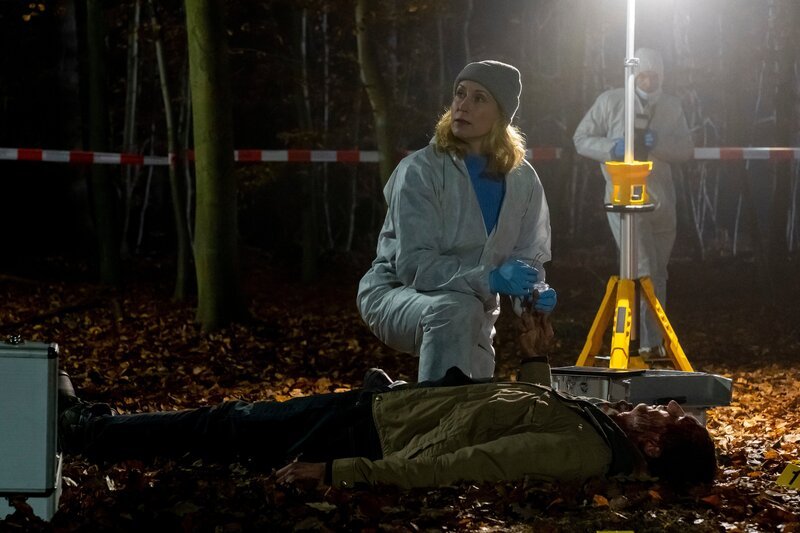 Dr. Judith Engel (Astrid Posner) untersucht die Stelle, wo die Leiche von Jens Tuchner (Boris Alexander) gefunden wurde. – Bild: Andrea Enderlein /​ ZDF