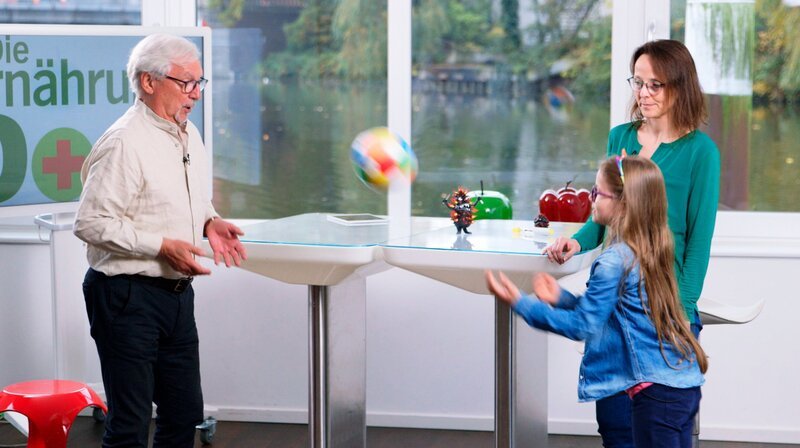 Der Ball wird ihr zugespielt: Mit der richtigen Ernährung soll die Siebenjährige den Entzündungsmann so klein wie möglich werden lassen, um so die vielen Medikamente möglichst reduzieren zu können. – Bild: NDR/​Moritz Schwarz