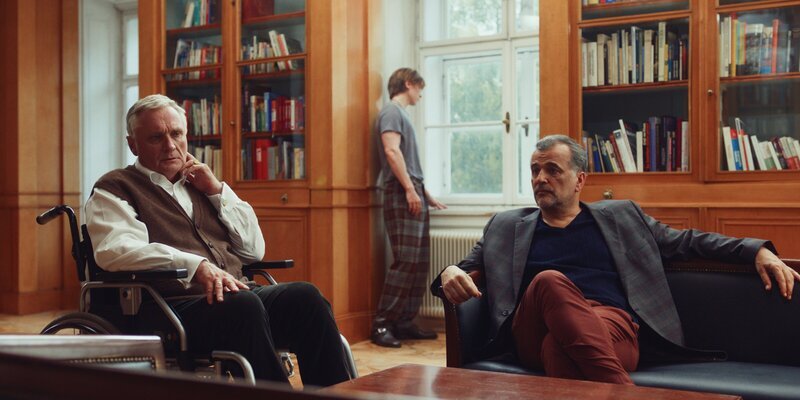 Marc (Michael Masula, r.) und Bernhard Dardenne (Bernhard Schir, l.) beraten über die hereinbrechende Krise, während Nicolas (Gustav Schmidt, M.) einen heimlichen Ausweg sucht. – Bild: Philip Jestädt /​ ZDF und Philip Jestädt