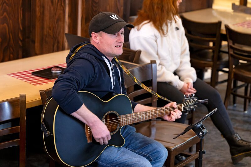 Martin beim Gitarrespielen im Domus Misericordiae. – Bild: Ralf Wilschewski /​ BR, Film Five GmbH