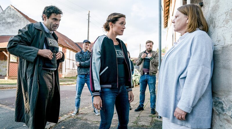 Marianne Hartmann (Hildegard Schroedter, re.) möchte Wächter (Andreas Döhler, li.), Kuba (Oleg Tikhomirov, 2. v. li.), Sunny (Friederike Becht) und Fechner (Christoph Letkowski) nichts über den Verbleib ihres Sohnes sagen. – Bild: ORF/​Beta Film/​Rowboat/​MDR/​Degeto/​Stephan Rabold