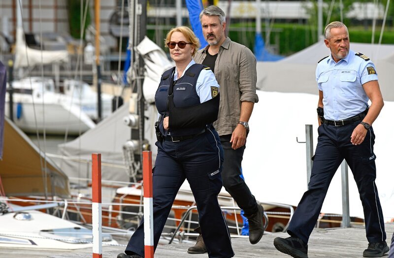 ARD WAPO BODENSEE, FOLGE 73, „Der Schuss“, am Dienstag um 18:50 Uhr im ERSTEN. Nele Fehrenbach (Floriane Daniel, l.), Gregor Mertens (Lukas Spisser, 2.v.r.) und Paul Schott (Tim Wilde,r.) ermitteln im Yachthafen. – Bild: ARD/​Laurent Trümper