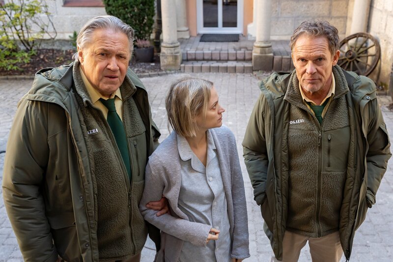Hubert (Christian Tramitz, r.) und Girwidz (Michael Brandner, l.) hoffen, dass die verwirrte Frau (Mavie Hörbiger, M.) in der Klinik vermisst wird. – Bild: Leonine /​ Thomas Neumeier