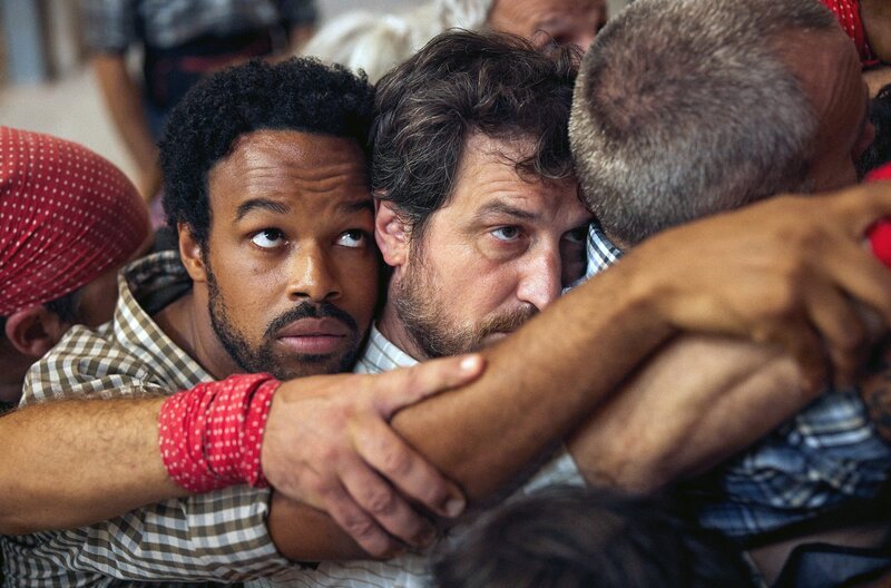 Daniel (Jean Cruz, li.) und Martí (Xavi Sáez, re.) bilden mit den anderen Männern des Dorfes die Basis des menschlichen Turms. – Bild: SWR/​Distinto Films/​Quim Vives