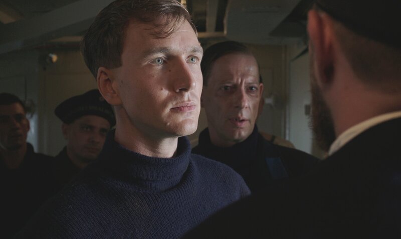 Hans Beimler (Jan Krauter) ist Obermaat bei der kaiserlichen Hochseeflotte in Cuxhaven.  im Hindergrund Luc Feit als Heester. – Bild: SWR/​LOOKSfilm/​J. Rehberg