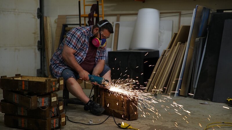Lucas sits while grinding some ammo boxes for the Gangster enclosure. – Bild: Animal Planet /​ Discovery Communications